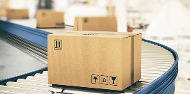 A line of packages rolling on a conveyor system in a warehouse