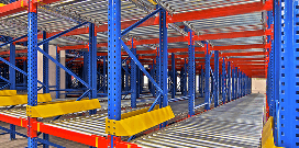 Blue and orange pallet flow rack with yellow barriers and rollers