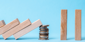 A worker uses a forklift to carry pallets with packages in a large warehouse